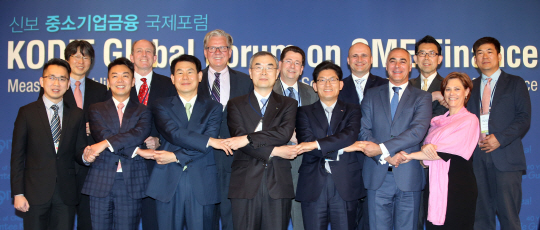 신용보증기금이 12일 서울 롯데호텔에서 창립 40주년을 맞아 개최한 '신보 중소기업금융 국제포럼'에서 서근우 신보 이사장(앞줄 가운데), 송재희 중소기업중앙회 상근 부회장(앞줄 오른쪽 세번째), 정은보 금융위 부위원장(앞줄 왼쪽 세번째) 등 참석자들이 기념촬영하고 있다.  연합뉴스